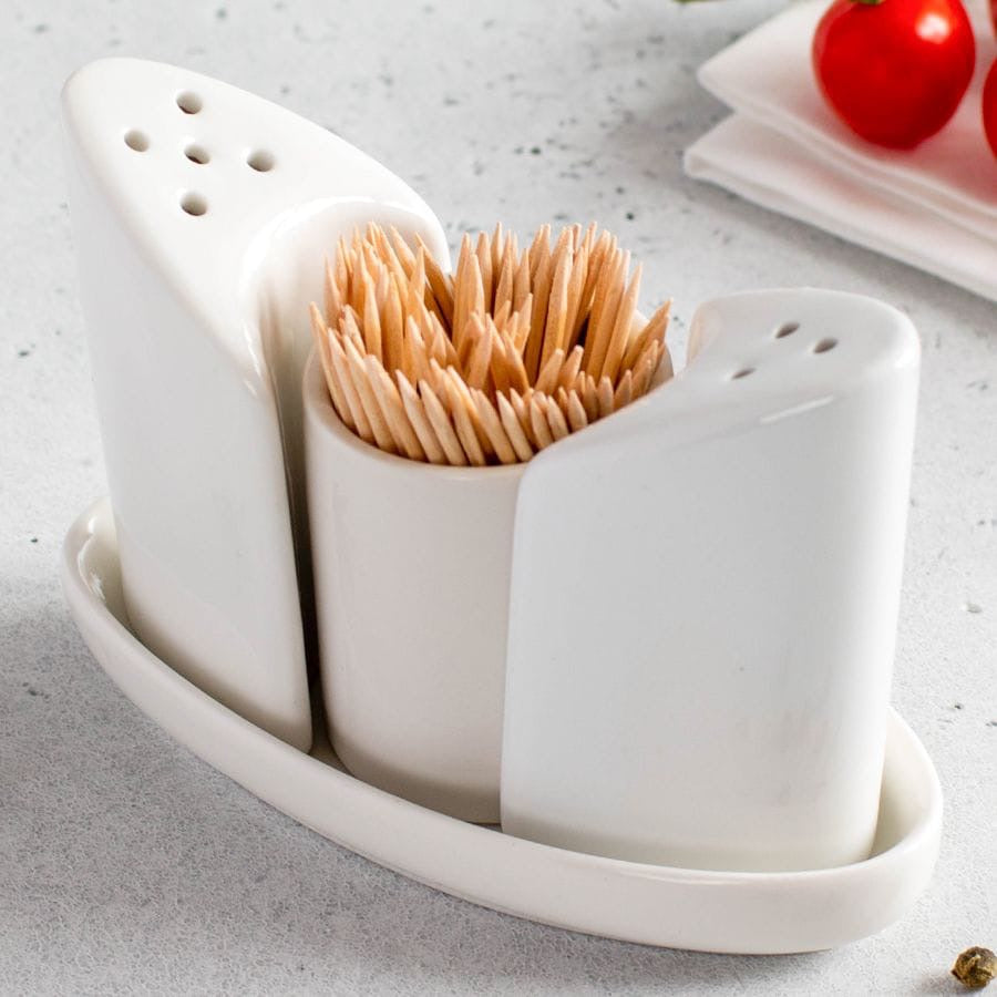Small ceramic 4-piece salt and pepper shaker set with bonus tray, suitable for storing spices on kitchen counters and dining tables.