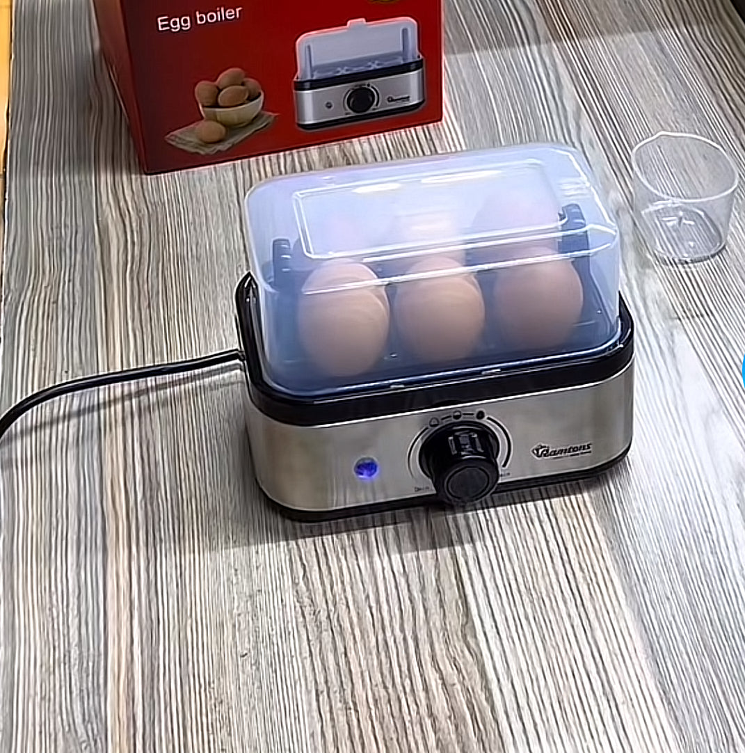 6-Slot Electric Egg Boiler Machine – Compact kitchen appliance for fast and easy egg boiling, ideal for home and office use.