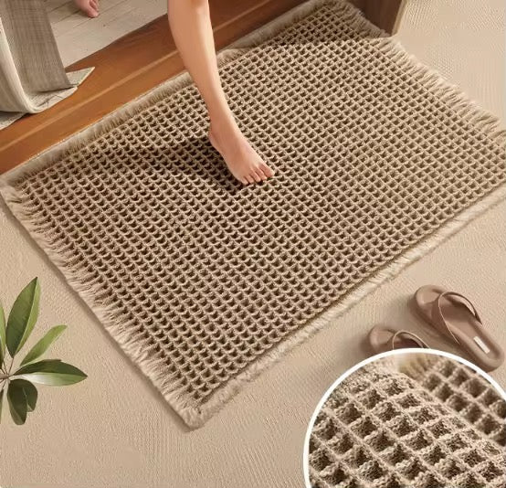 Minimalist brown waffle bathroom door mat 46x77cm with non-slip backing placed at doorway.