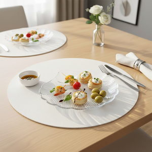 Clear shell shaped glass plate for serving appetizers, desserts, or snacks with elegant presentation