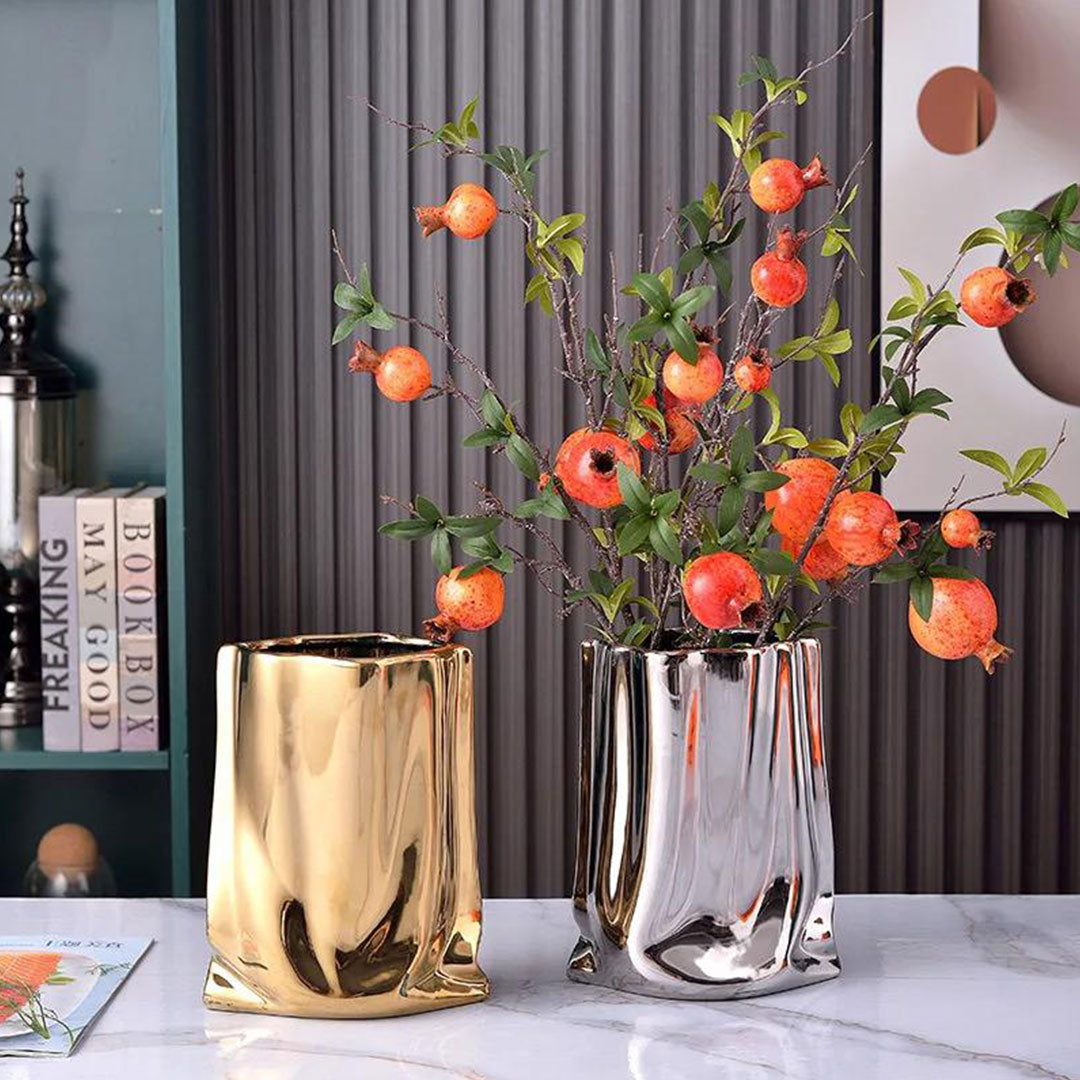 metallic ceramic vase with crumpled design, contemporary decorative piece for medium to large floral arrangements.