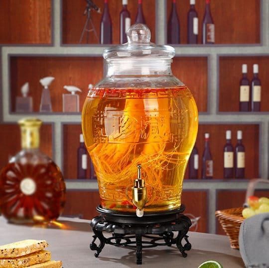 5L glass beverage dispenser with faucet, PVC stand and glass lid for serving drinks at home, parties and gatherings.