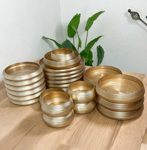 24-piece gold and brown brushed glass dinner set with glossy finish, including dinner plates, side plates, bowls and small soup bowls.