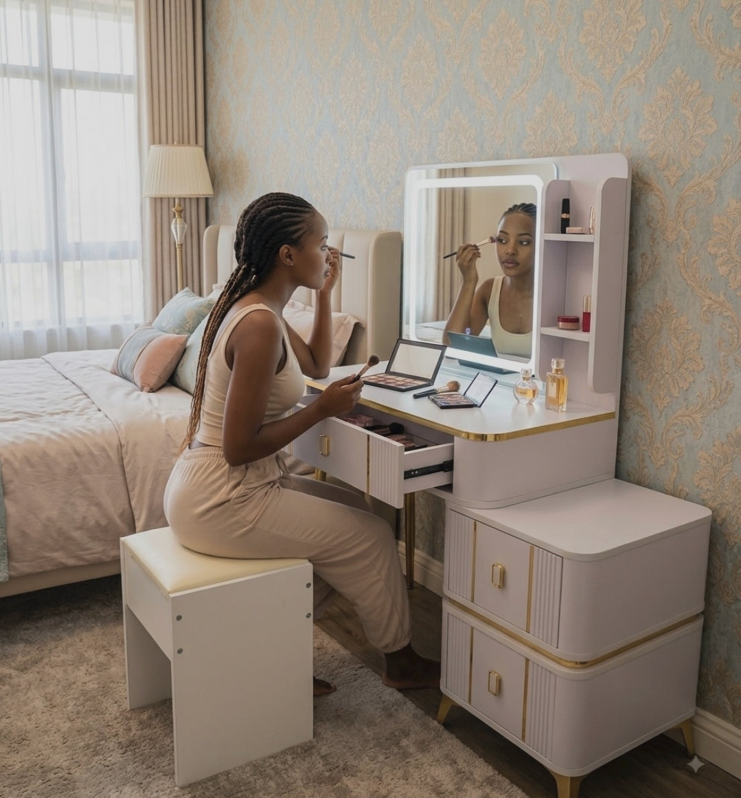 Light grey and gold vanity dressing table with integrated rectangular LED mirror, drawers, side shelving, and fluted panel design for organised bedroom storage