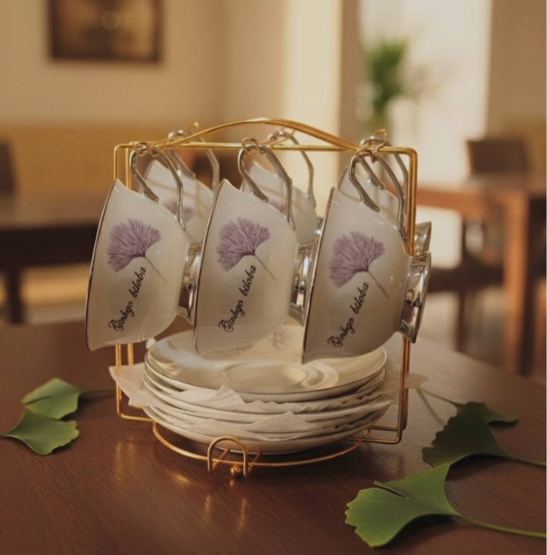 Gemelli Collections bone china cup and saucer set with gold stand featuring 6 cups, 6 saucers, white finish and silver detailing.