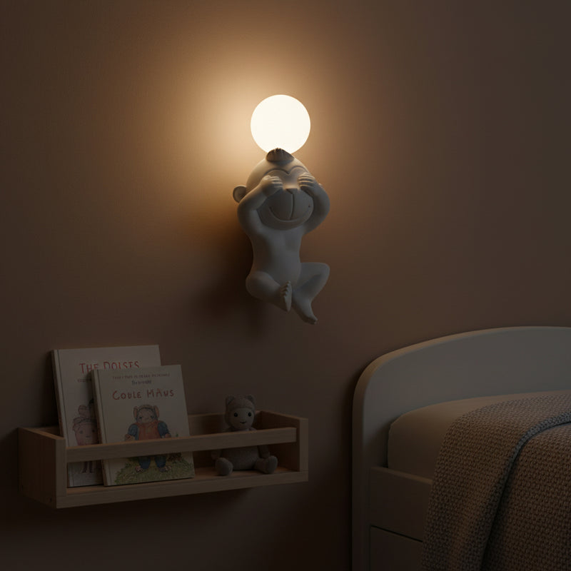 Gemelli Collections monkey see no evil LED wall sconce in matte white resin with frosted globe light, decorative wall-mounted lamp for kids' rooms and playful interiors.