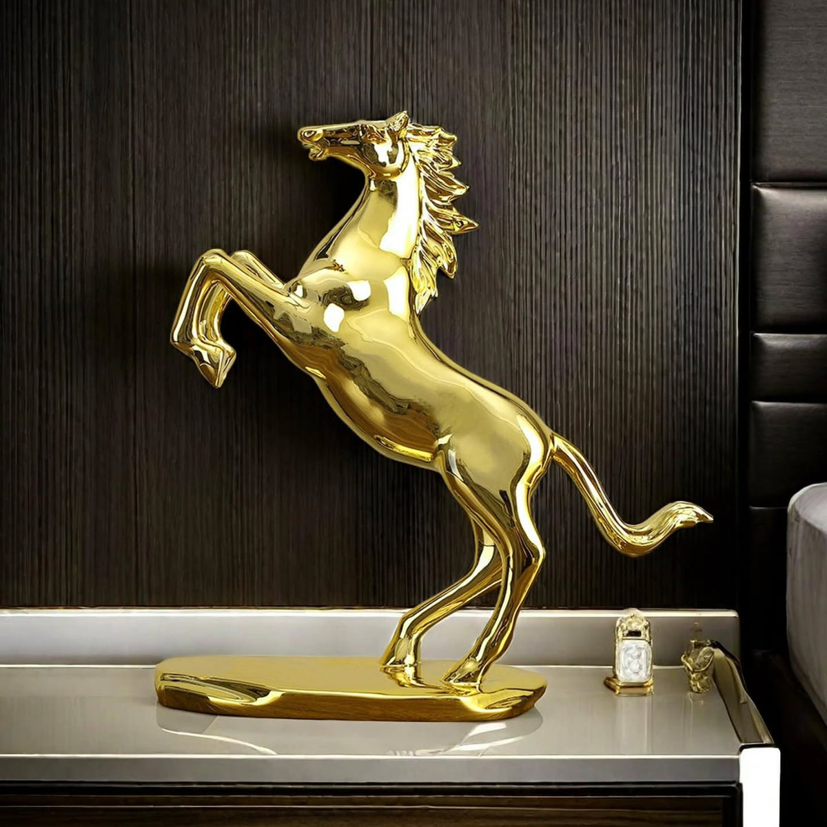 Gemelli Collections golden rearing horse statue with mirror gold finish, detailed flowing mane and tail, mounted on an oval base for luxury home and office décor.
