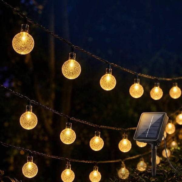 12 metre solar powered outdoor Christmas string lights with 100 decorative LED balls for festive garden and patio décor.