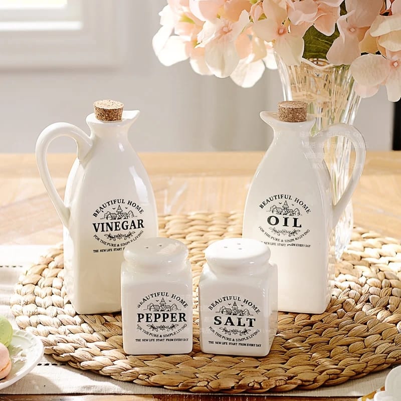4-piece kitchen cruet jar set containing an oil jar, vinegar jar, salt shaker and pepper shaker for organised condiment storage.