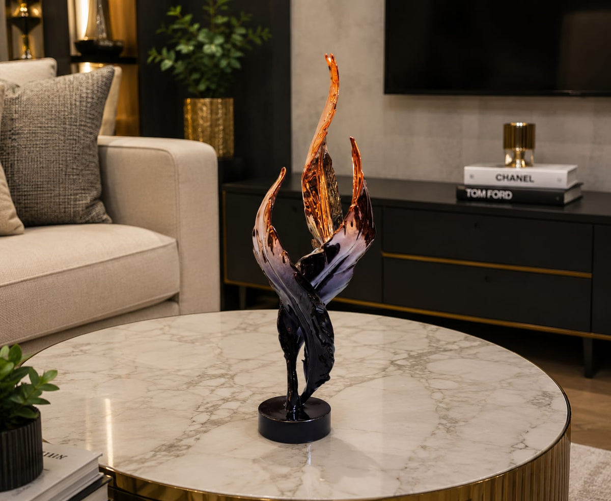 Gemelli Collections black and copper twisted feather sculpture featuring three abstract resin feathers with metallic copper tips on a glossy black round base for luxury home and office décor.