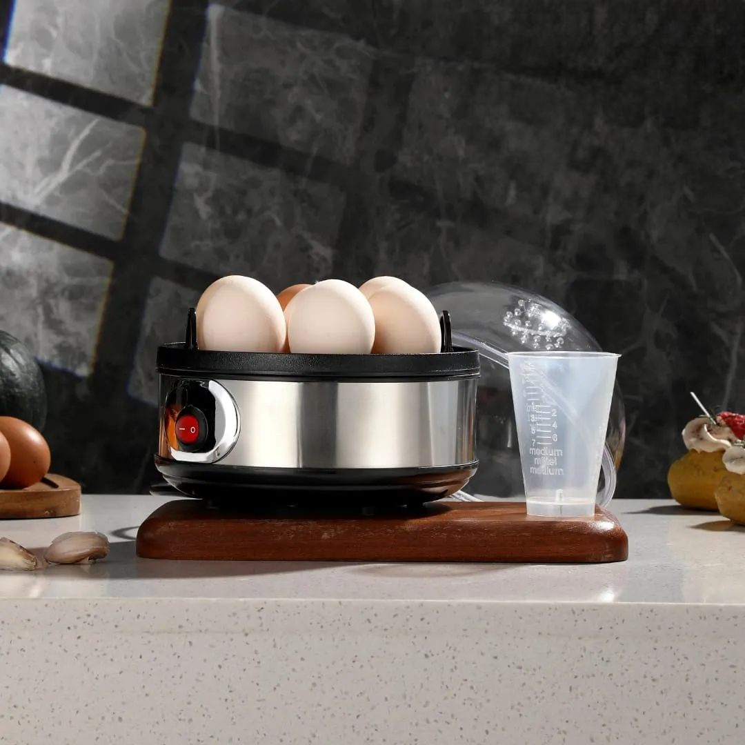 electric egg boiler with steam rack and measuring cup for boiling up to 7 eggs simultaneously at home, in hostels, or offices