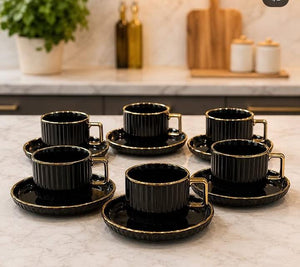 European-style ceramic coffee cup and saucer set with six ribbed 300ml mugs, gold-plated handles, and six matching saucers, available in black and white