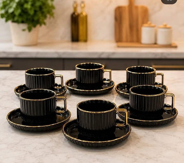 European-style ceramic coffee cup and saucer set with six ribbed 300ml mugs, gold-plated handles, and six matching saucers, available in black and white