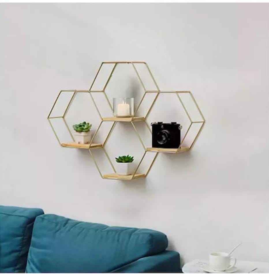 Gemelli Collections 4-piece gold hexagon floating wall shelf set with natural wood bases in a geometric honeycomb design for decorative home storage and display.