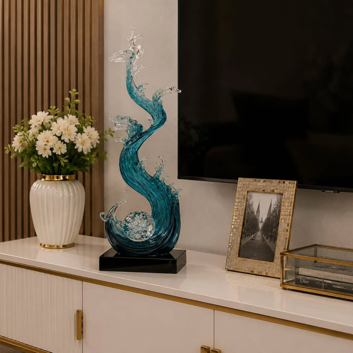 Gemelli Collections 75cm ocean wave resin sculpture featuring flowing blue and clear translucent waves spiralling around a crystal ball on a black display base.