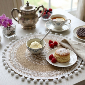 Gemelli Colllection 6-piece boho round woven table mat set with lace detail and pom-pom edges