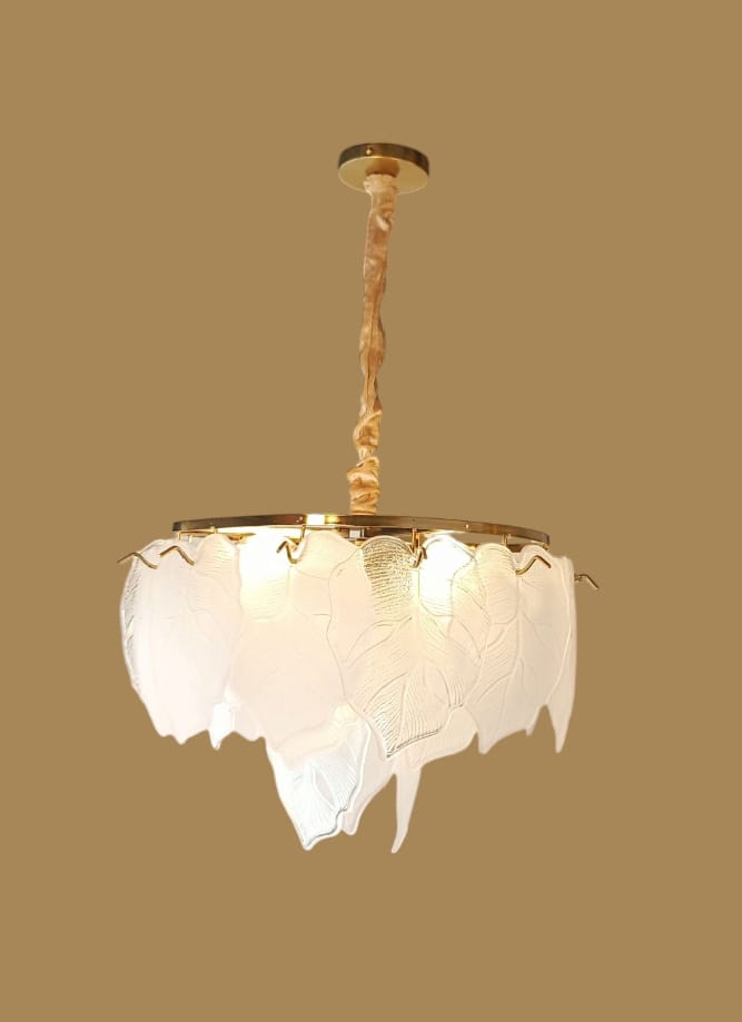 Glass leaf chandelier with circular metal frame and radiating hand-blown leaves illuminated by warm LED light in an organic botanical design.