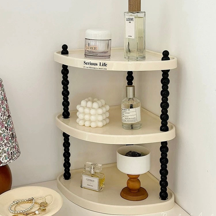 Multilayer desktop storage rack for organising perfumes, cosmetics, candles, toiletries, kitchen accessories, and decorative items on countertops and desks.