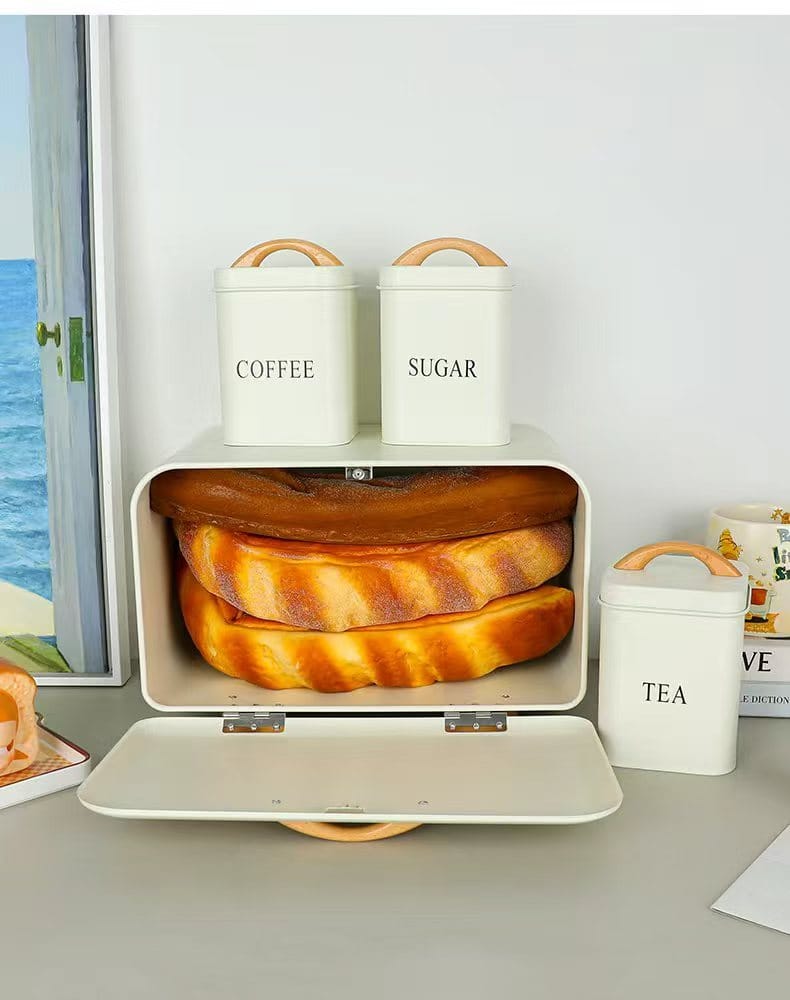 4 piece cream metal bread bin and tea coffee sugar canister set with airtight lids wooden handles and stackable kitchen storage design.