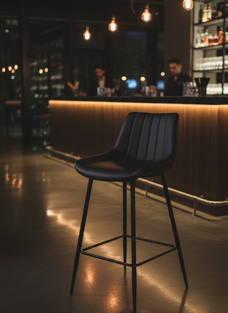 Black bar stool with padded seat and sturdy frame for home or commercial