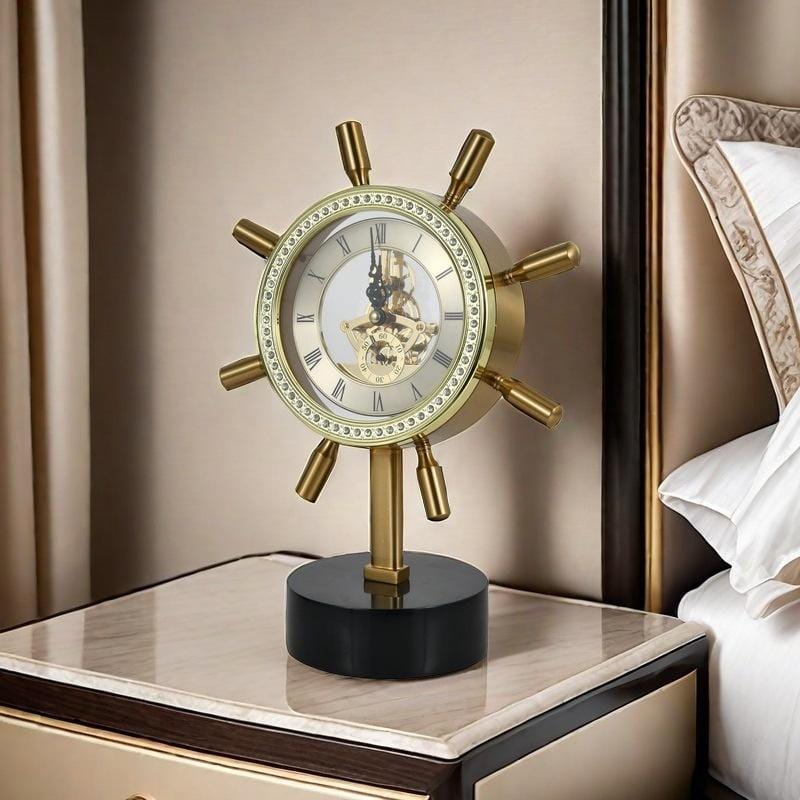 Captain steering metallic desktop clock with marble base displayed on a desk as nautical decor.