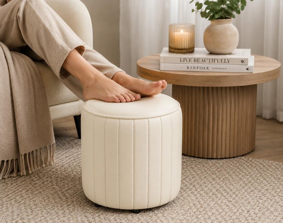 Multi-purpose PU leather footstool measuring 30cm diameter and 30cm height for use as a footrest, vanity stool, entryway stool, and extra seating