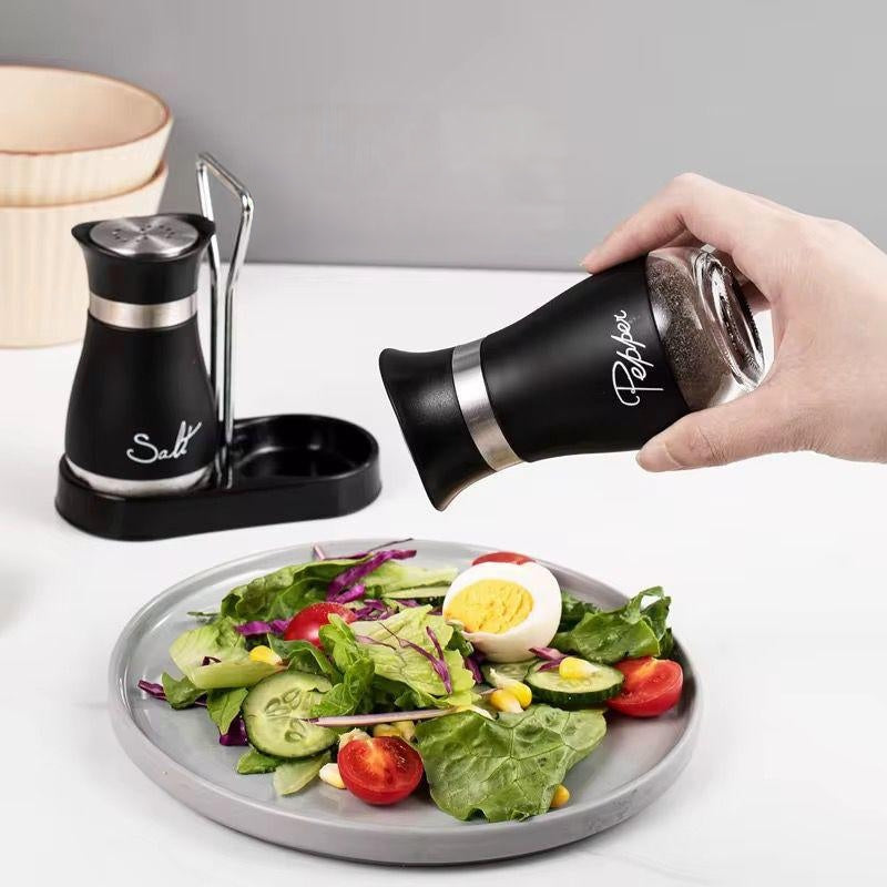 Glass salt and pepper shaker set with holder for organised seasoning storage on kitchen countertops and dining tables, available in black and white