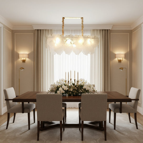 Linear glass leaf chandelier with gold frame and layered frosted Murano-style leaves creating a soft glowing botanical pendant light.