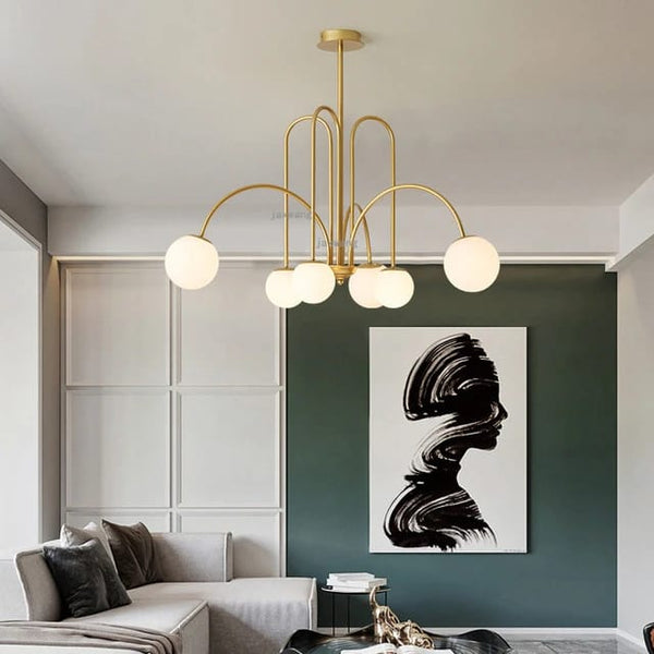 Brass arch chandelier with asymmetrical arms and opal glass globe shades modern bubble ceiling light for living room and dining interiors