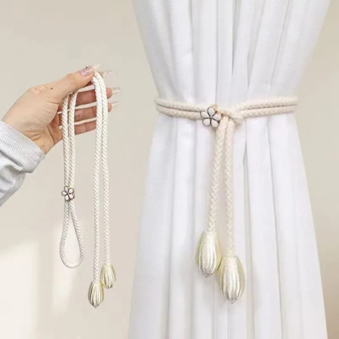 Curtain tieback holding window curtains neatly to the side for an organised and tidy room appearance.