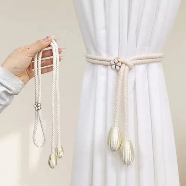 Curtain tieback holding window curtains neatly to the side for an organised and tidy room appearance.