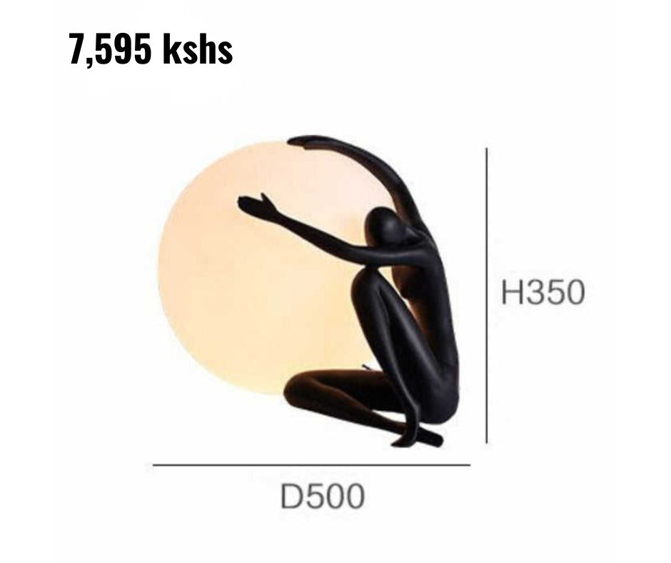 Gemelli Collections modern abstract figure globe lamp in matte black with frosted LED globe, sculptural resin design, and warm ambient lighting for luxury home and office décor.