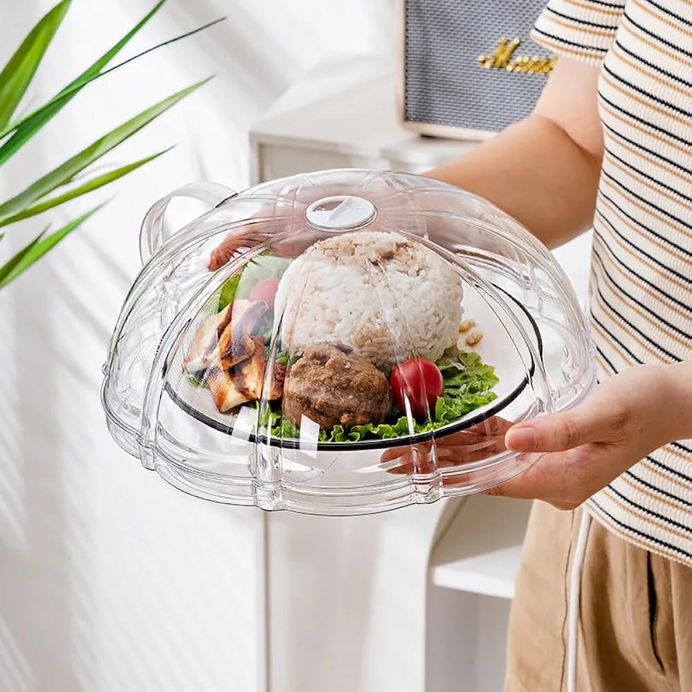 Transparent microwave food splatter cover with integrated base plate, top handle, and steam ventilation for cleaner and more convenient food reheating.