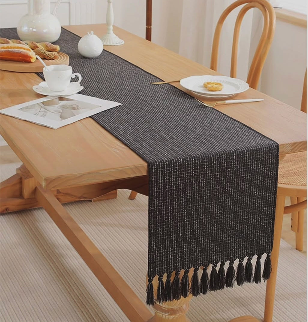Woven dining table runner measuring 33cm x 228cm with decorative tassel edges for table protection and dining room décor