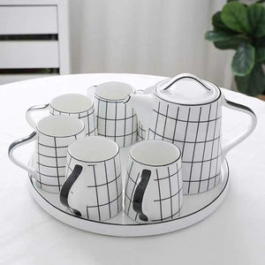 8-piece checked design tea and coffee set with six ceramic cups, one ceramic kettle, and a matching round ceramic tray for serving tea and coffee at home or when entertaining guests