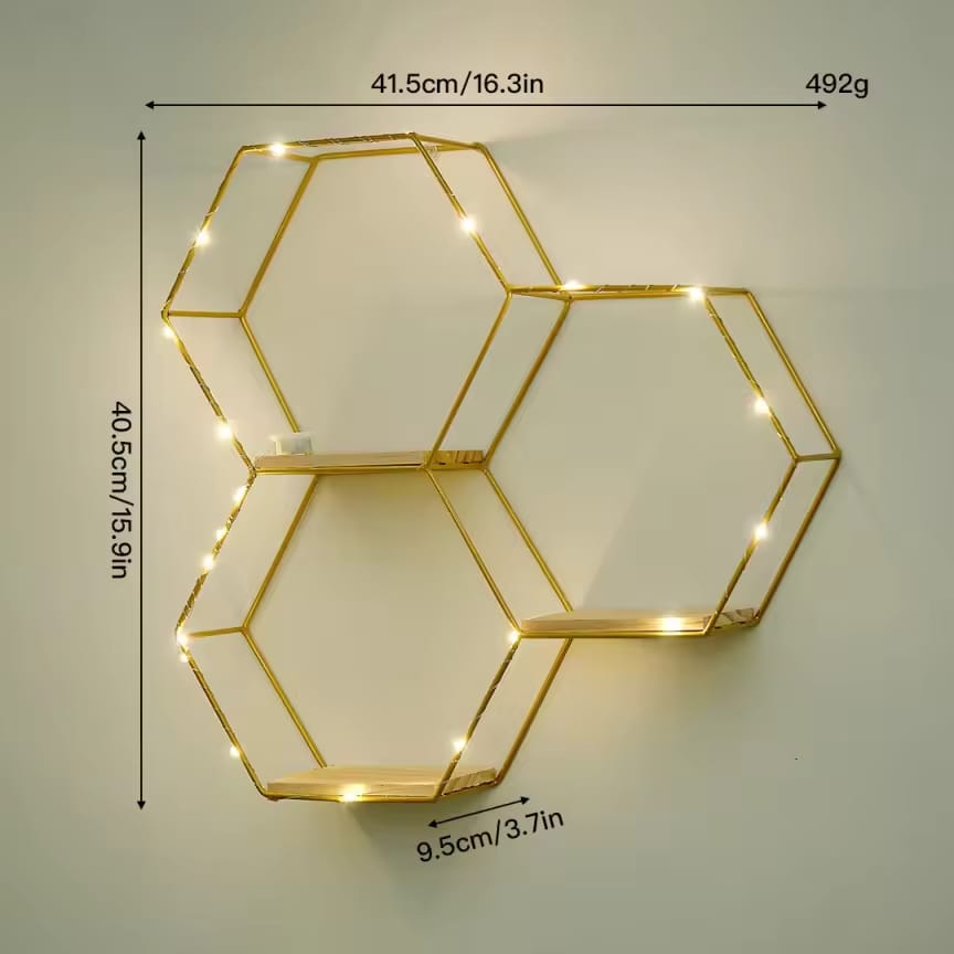 Gemelli Collections 3-piece gold hexagon floating wall shelf with natural wood bases and warm LED fairy lights in a geometric honeycomb design.
