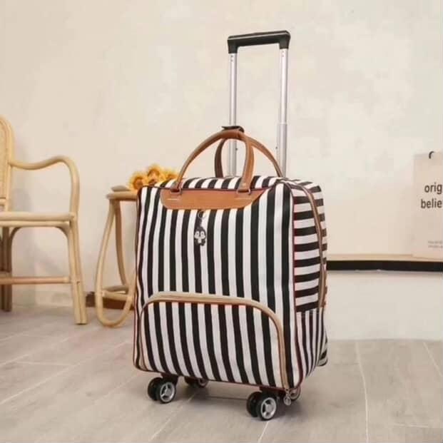 Gemelli Collections high quality trolley travel bag with 4 universal wheels and black-and-white striped waterproof design.