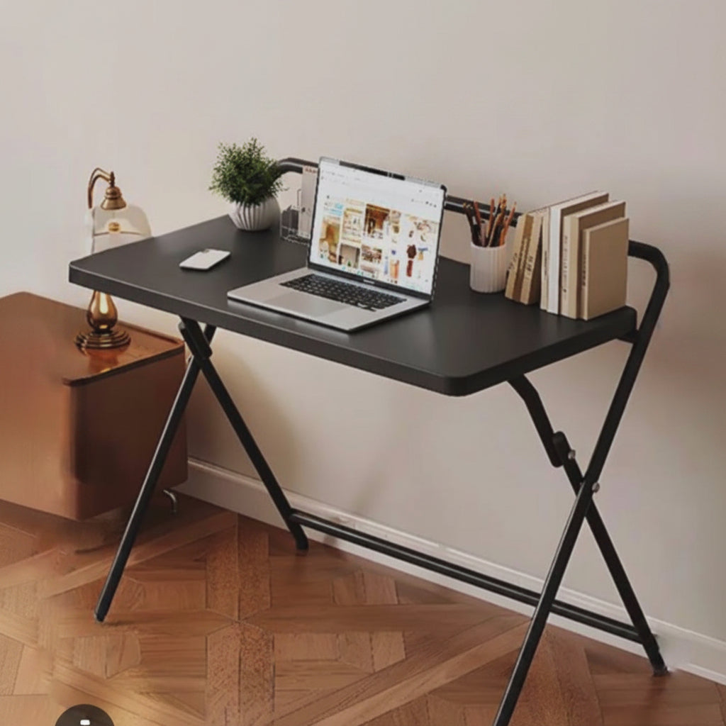Portable folding table with spacious tabletop and strong metal frame available in white and black for dining work study and small space use.