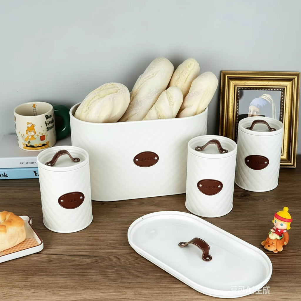 4-piece quilted metal bread bin and canister set with rope handle, airtight lids, and labelled Coffee, Sugar, and Tea containers for kitchen storage