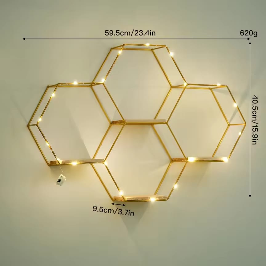 Gemelli Collections 4-piece gold hexagon wall shelf with natural wood bases and warm LED fairy lights in a geometric honeycomb floating design.