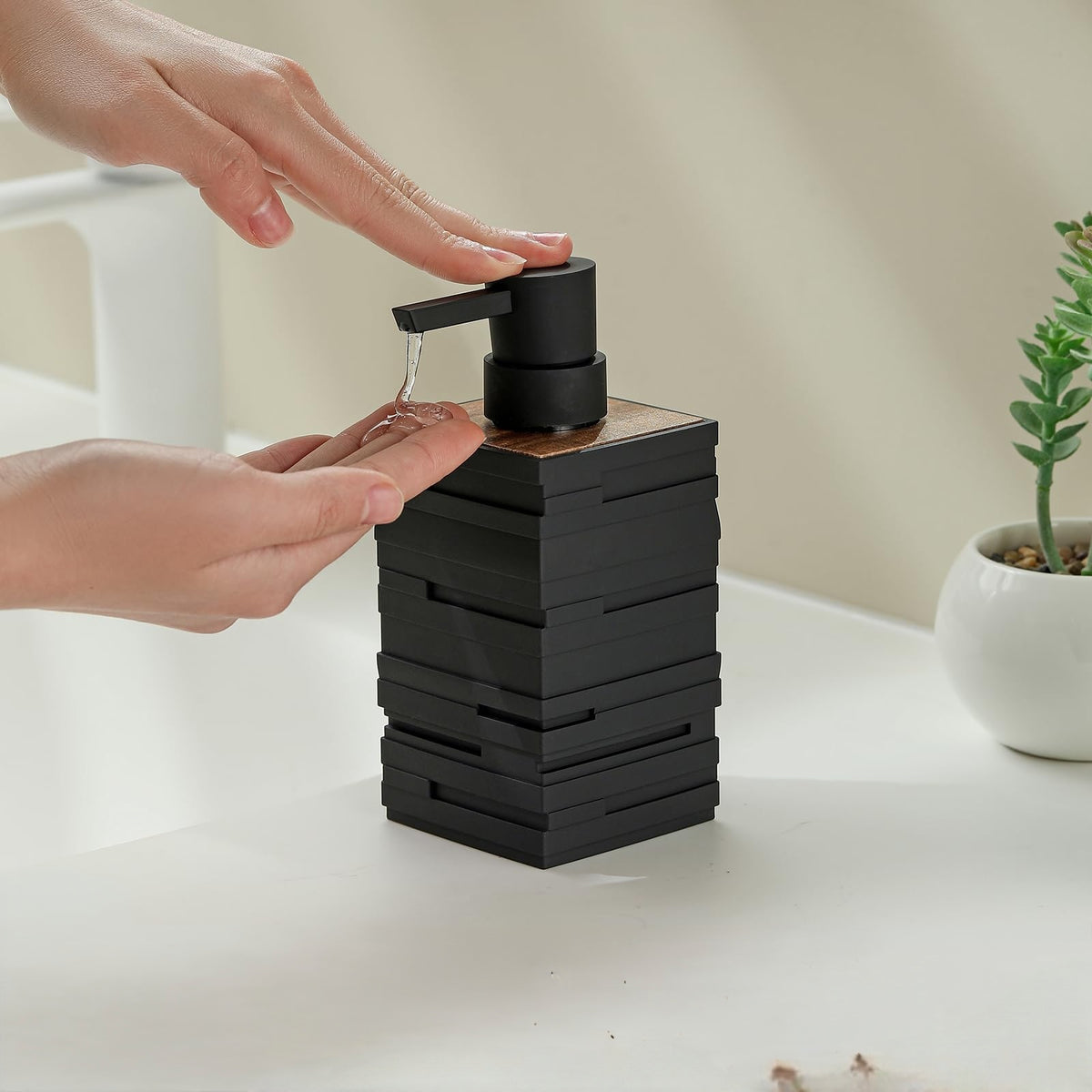 Stacked design soap dispenser made from hard plastic available in white grey black and beige for bathroom and kitchen use.