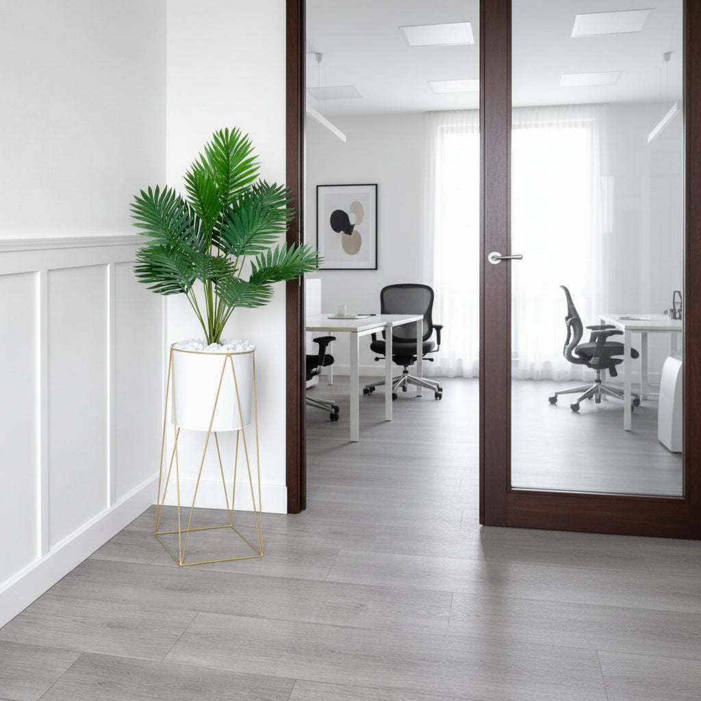 Metallic stand vase with artificial plant and decorative pebbles