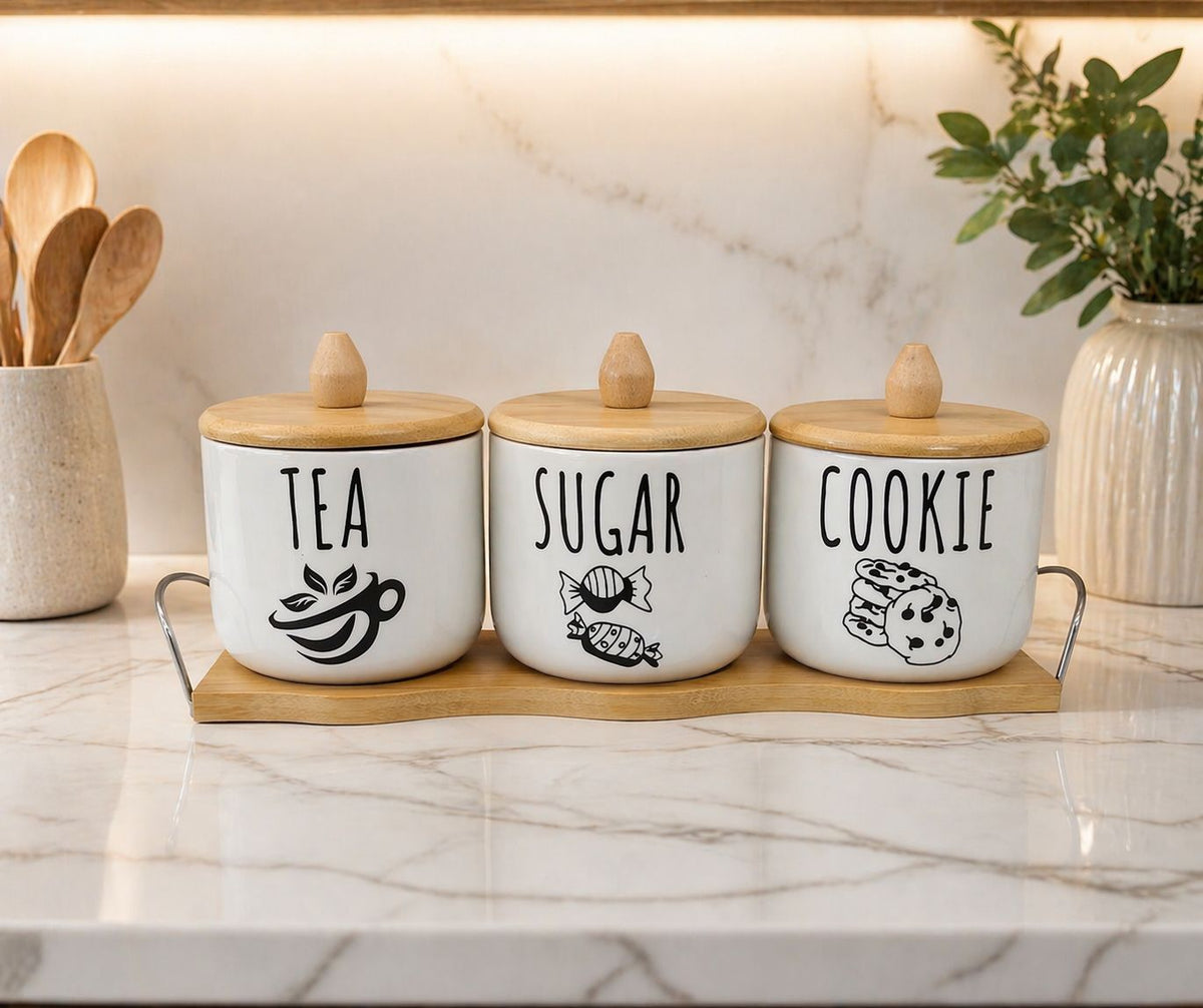 Gemelli Collection 4pc airtight canister set with wooden lids and tray used for storing tea, sugar, coffee and cookies in a modern kitchen