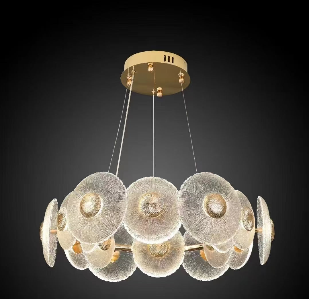 Gold ring chandelier with layered frosted petal discs and integrated LED lighting creating a soft organic halo effect.